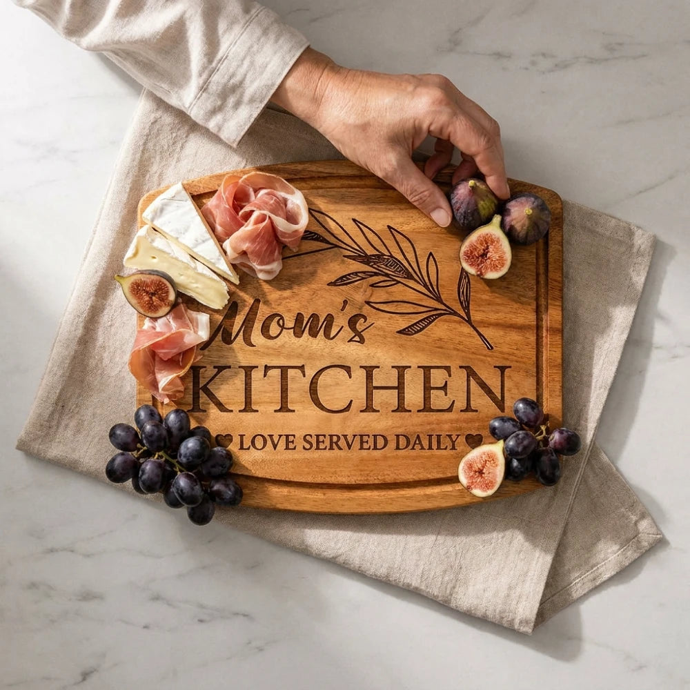 Hand_taking_fig_from_Mom_s_Kitchen_engraved_board_with_cheese