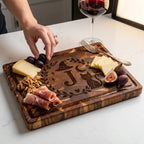 Hand_taking_grapes_from_Halloween_engraved_end-grain_charcuterie_board