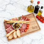 Nicole_and_Bob_engraved_board_with_charcuterie_and_oil_bottles