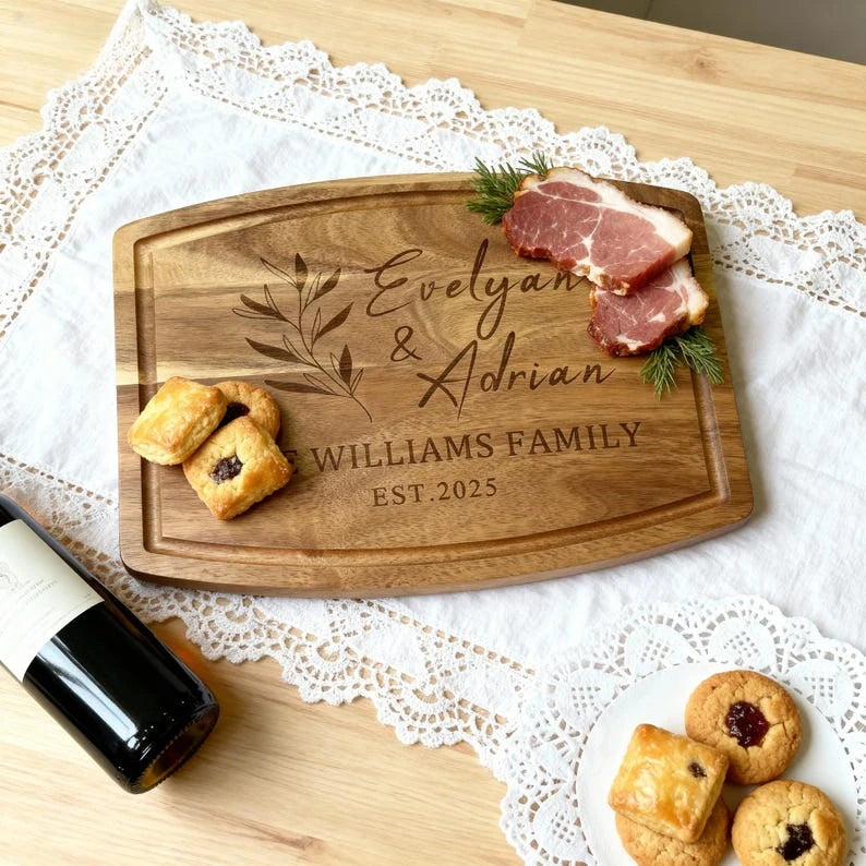 Overhead_view_of_Evelyan_and_Adrian_engraved_board_with_meat_and_pastries
