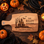 Overhead_view_of_Halloween_haunted_house_engraved_board_on_dark_table