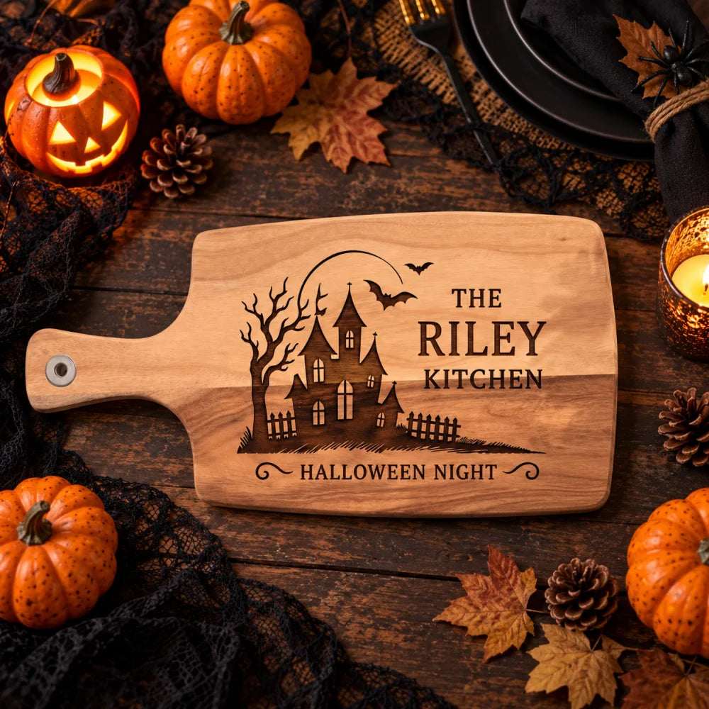 Overhead_view_of_Halloween_haunted_house_engraved_board_on_dark_table