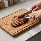 Person_carving_steak_on_Smith_Family_engraved_wooden_board